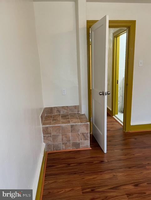 hallway featuring dark hardwood / wood-style flooring