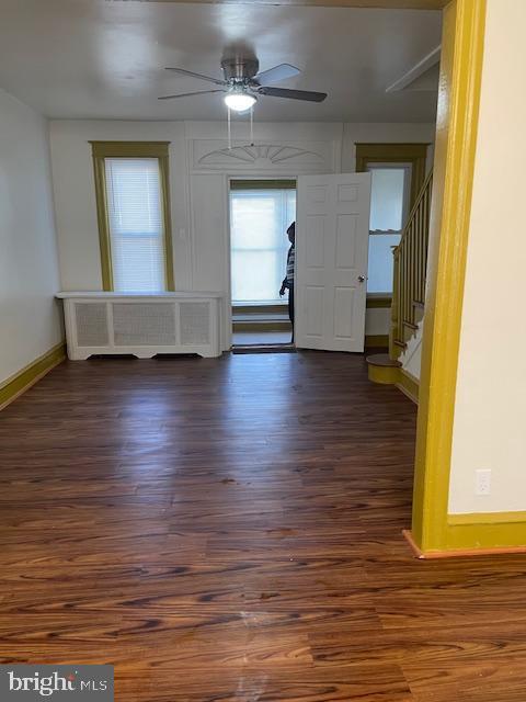 spare room with ceiling fan and dark hardwood / wood-style floors