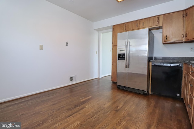 kitchen featuring dark hardwood / wood-style floors, dishwasher, and stainless steel fridge with ice dispenser