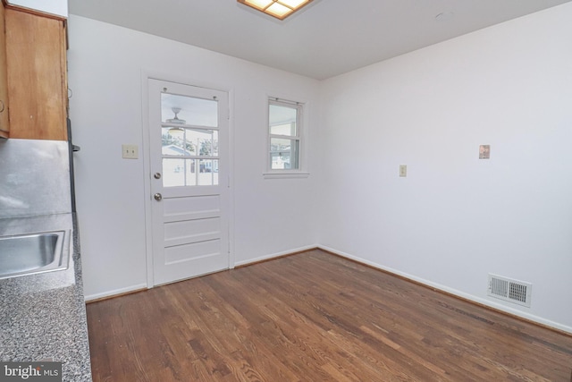 doorway to outside featuring sink and dark hardwood / wood-style flooring