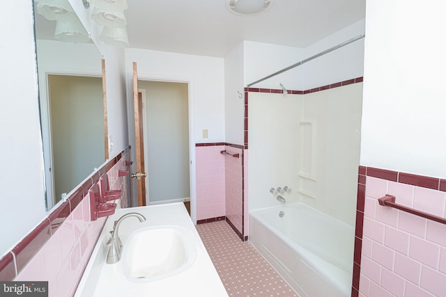 bathroom featuring shower / tub combination, vanity, and tile walls