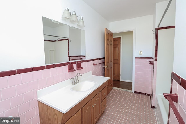 bathroom with vanity and tile walls