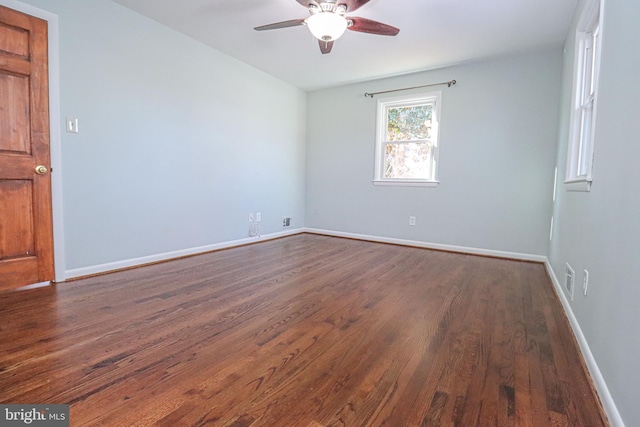 spare room featuring ceiling fan and dark hardwood / wood-style floors