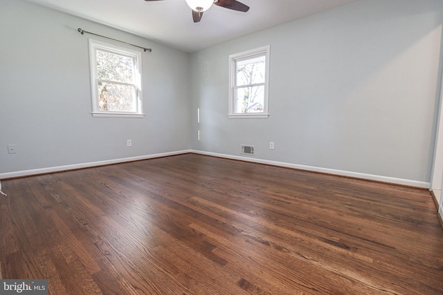 empty room featuring dark hardwood / wood-style floors and ceiling fan