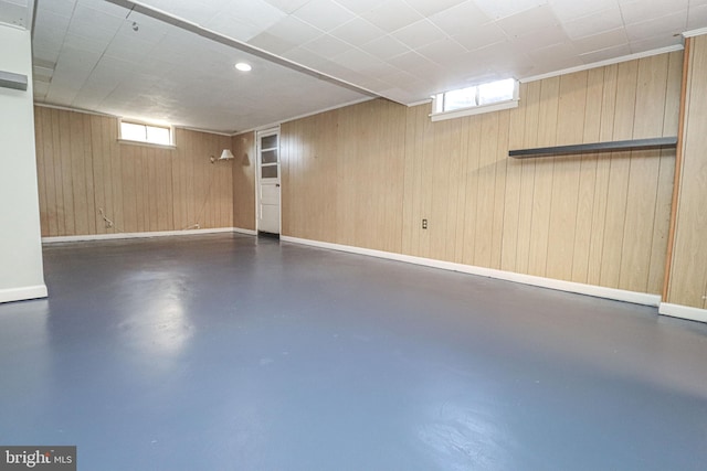 basement featuring wooden walls