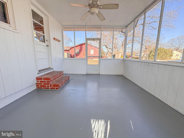 unfurnished sunroom featuring ceiling fan