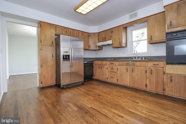 kitchen with dark wood-type flooring, sink, and black appliances