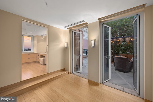 hallway with light hardwood / wood-style flooring