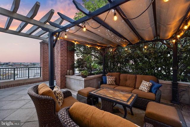 patio terrace at dusk featuring a water view, an outdoor hangout area, and a pergola