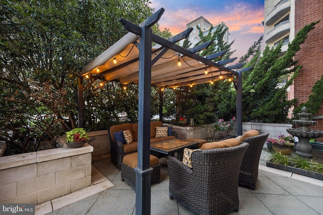 patio terrace at dusk featuring an outdoor living space and a pergola