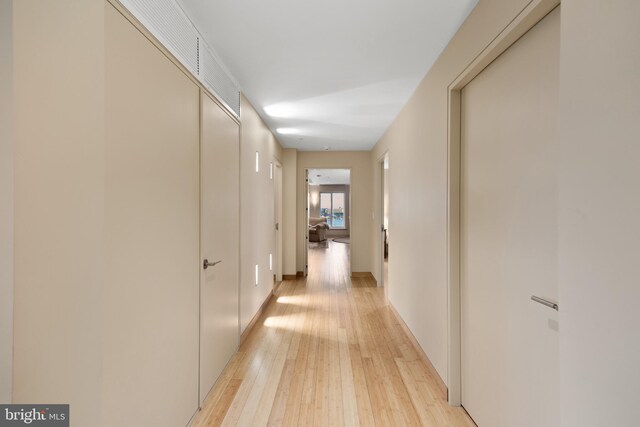 corridor with light wood-type flooring