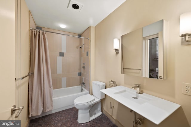 full bathroom featuring toilet, sink, and shower / bath combo with shower curtain