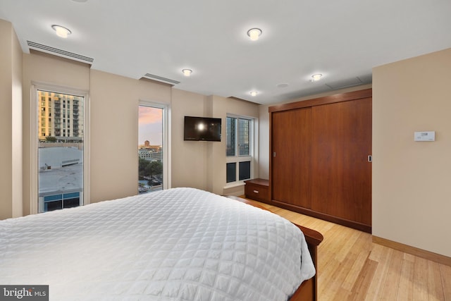 bedroom featuring light hardwood / wood-style floors and a closet