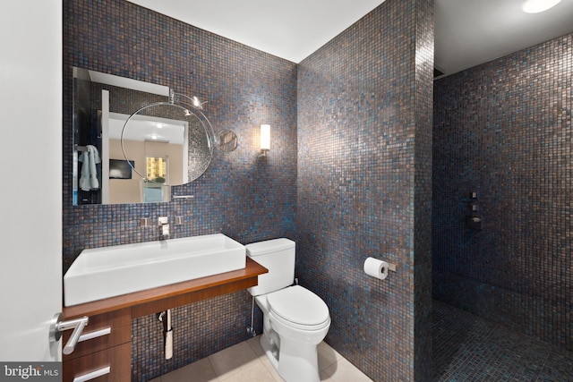 bathroom with sink, tile walls, backsplash, toilet, and tile patterned floors