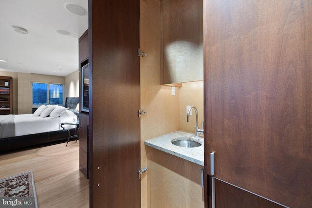 bathroom with vanity and wood-type flooring