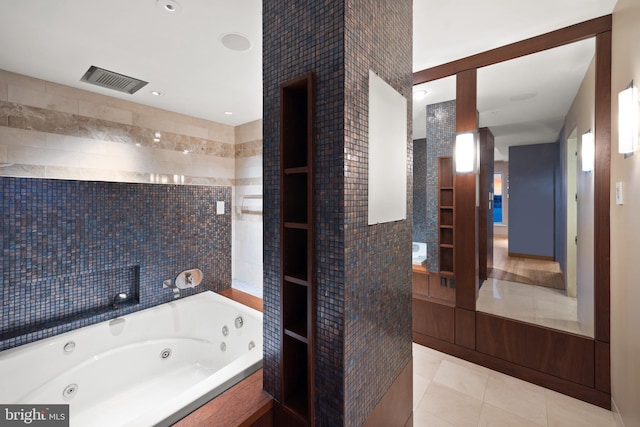 bathroom featuring tile patterned flooring, tile walls, and a bathing tub