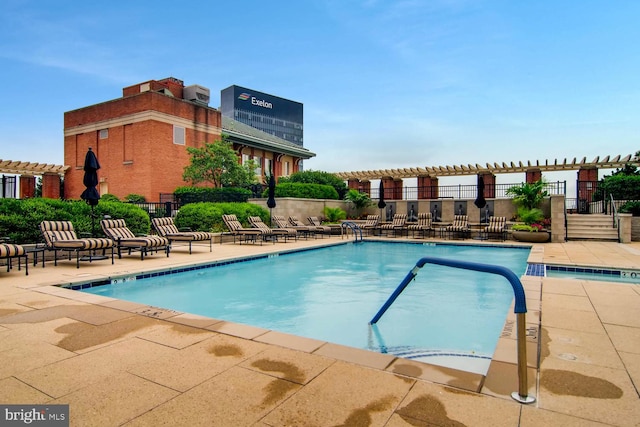 view of swimming pool featuring a pergola and a patio area