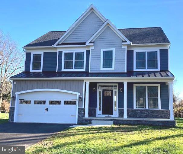 1394 B And A Blvd, Arnold, MD 21012 - craftsman-style home with a standing seam roof, a porch, metal roof, stone siding, and a front lawn