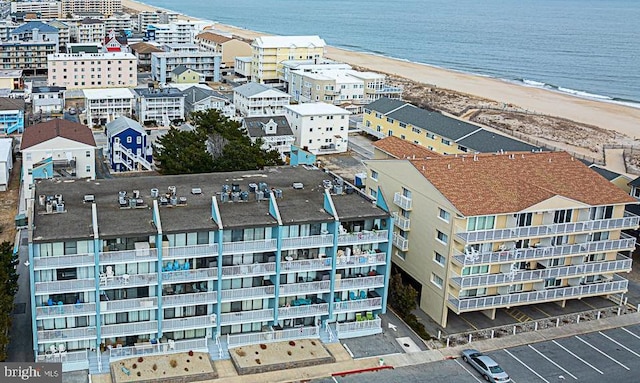 drone / aerial view featuring a water view and a beach view