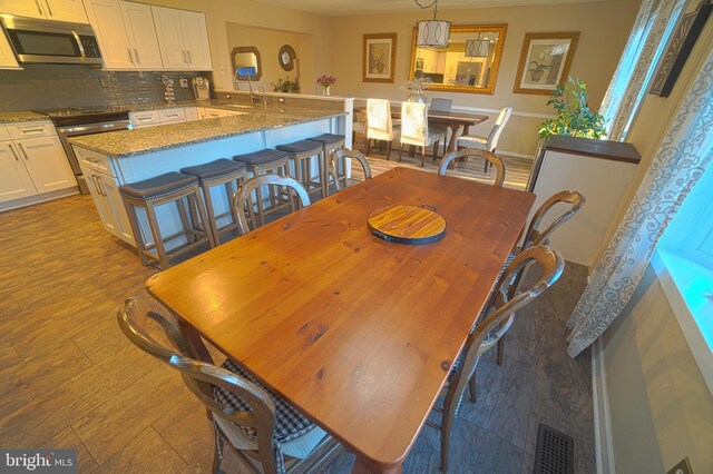 dining area with light hardwood / wood-style floors and sink