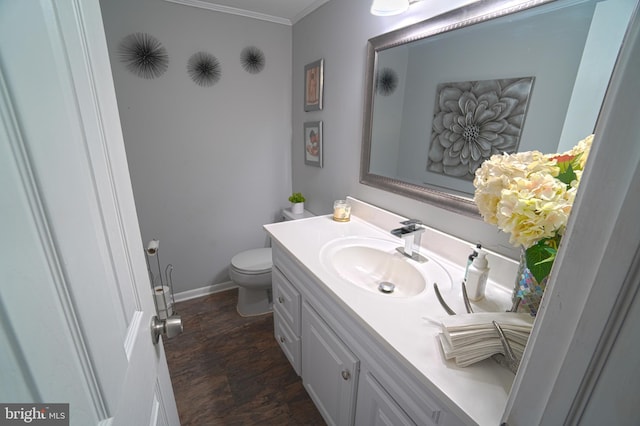 bathroom featuring vanity, crown molding, and toilet