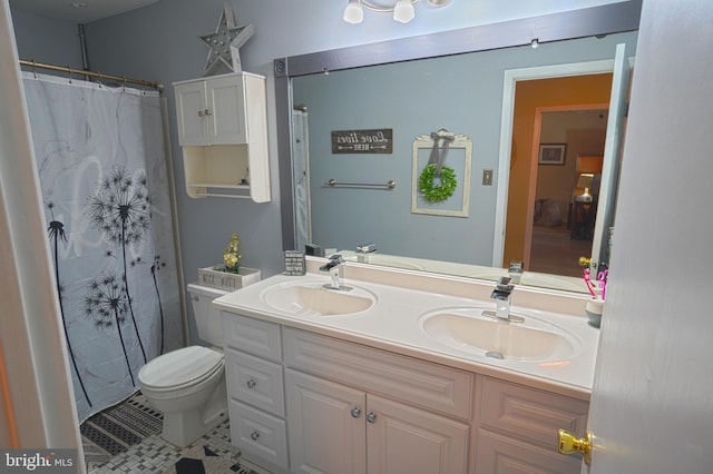 bathroom with vanity, tile patterned flooring, toilet, and walk in shower