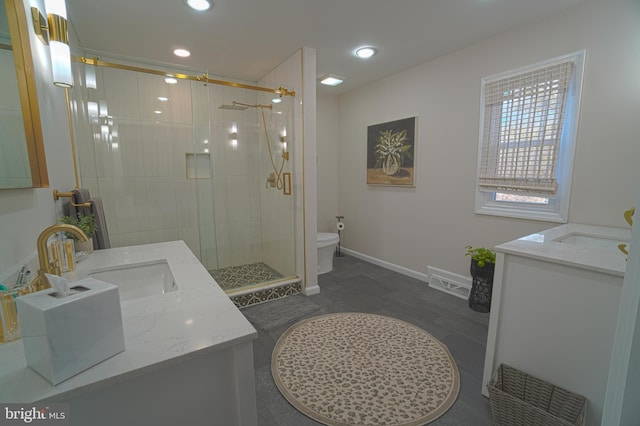 bathroom featuring vanity, toilet, and walk in shower