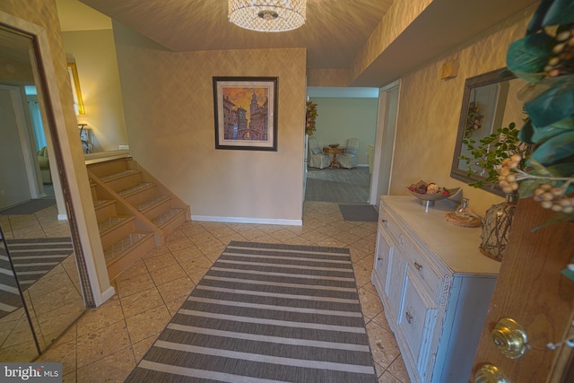 interior space featuring tile patterned flooring and a notable chandelier