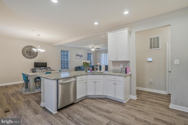 kitchen with white cabinets, light stone countertops, sink, and dishwasher