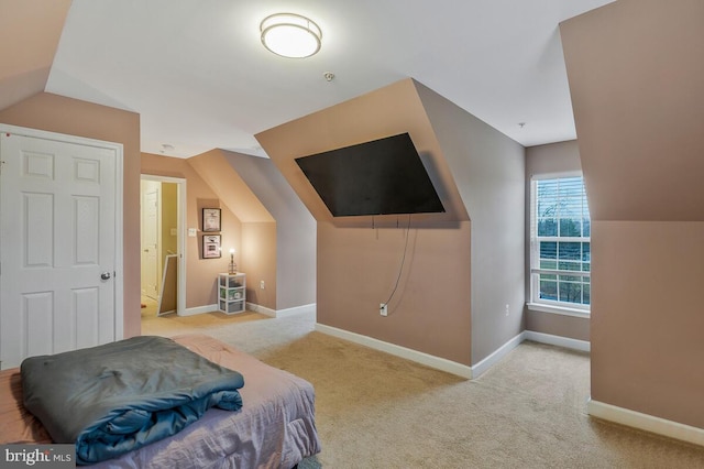 carpeted bedroom featuring lofted ceiling