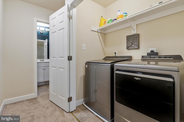 washroom with independent washer and dryer, sink, and light colored carpet