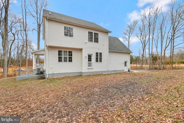 rear view of house featuring covered porch and central air condition unit