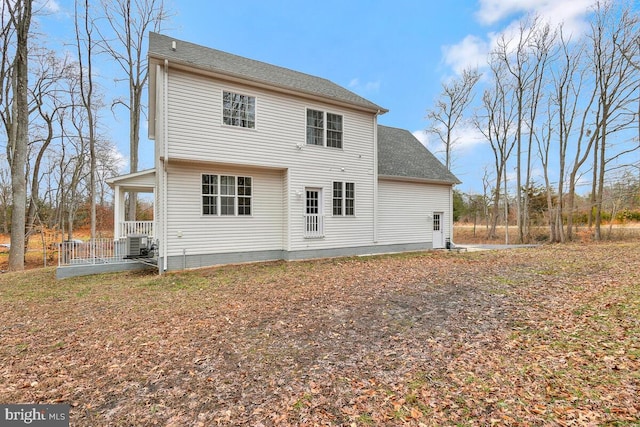 rear view of property with central AC unit and covered porch