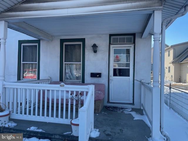 property entrance with covered porch