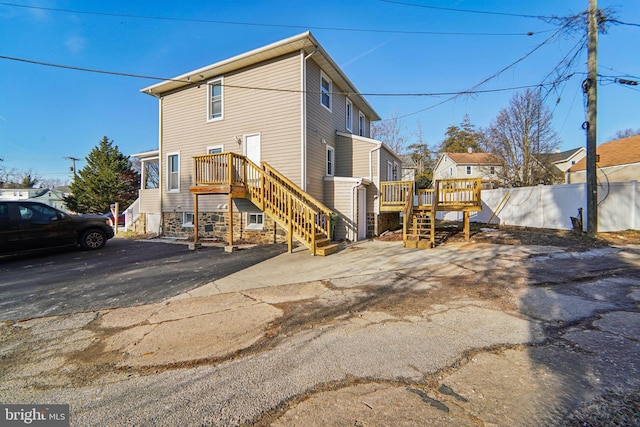 back of property featuring a wooden deck