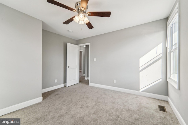 empty room with light carpet and ceiling fan