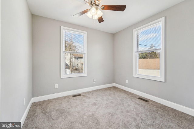 carpeted empty room featuring ceiling fan