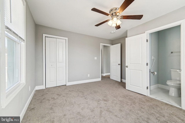 unfurnished bedroom with ceiling fan, light colored carpet, connected bathroom, and a closet