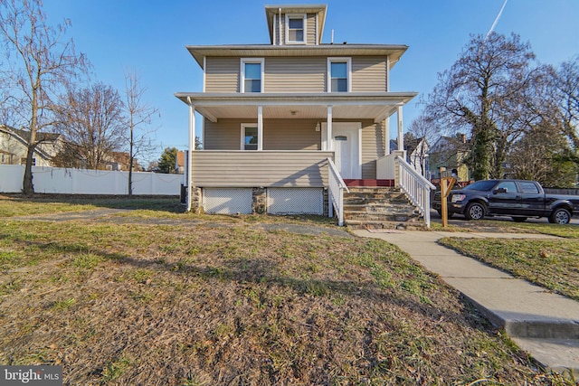 view of front facade featuring a front yard and covered porch