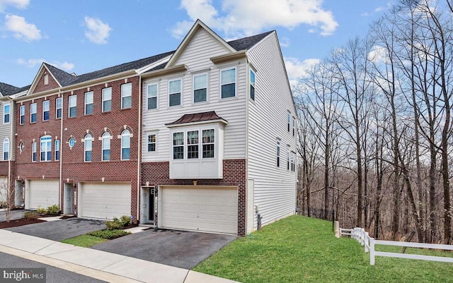 multi unit property featuring a garage and a front yard