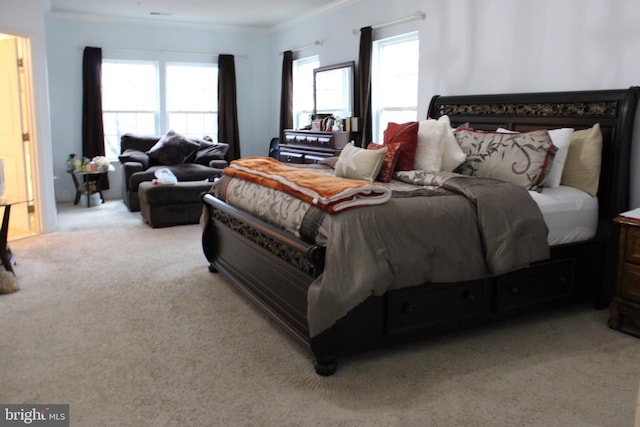 bedroom featuring multiple windows, crown molding, and light colored carpet