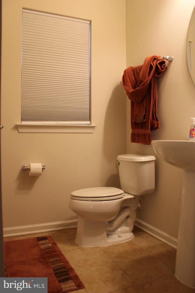 bathroom with tile patterned floors and toilet