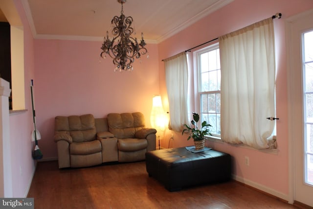 living room featuring crown molding, a chandelier, and hardwood / wood-style floors