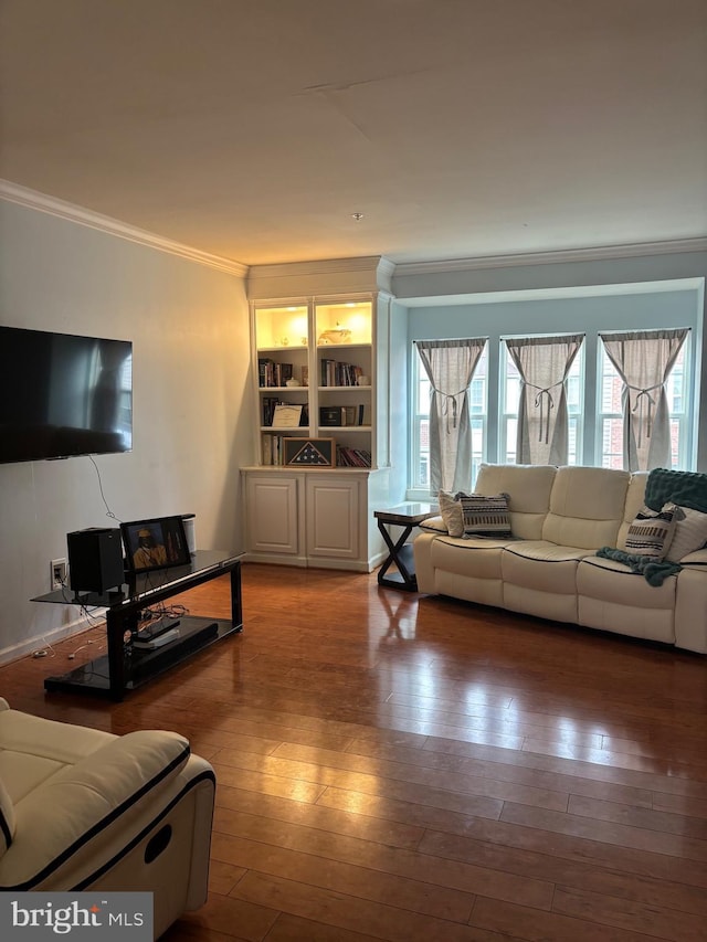 living room featuring wood-type flooring and crown molding