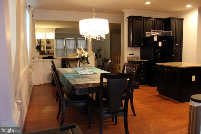 dining area featuring hardwood / wood-style floors and crown molding