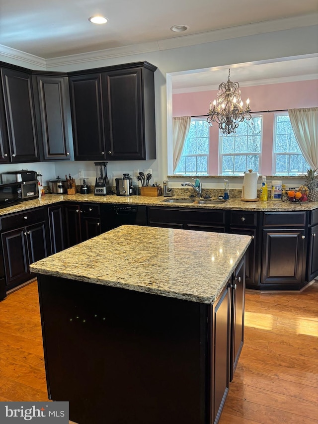 kitchen featuring a kitchen island, pendant lighting, sink, plenty of natural light, and light hardwood / wood-style flooring