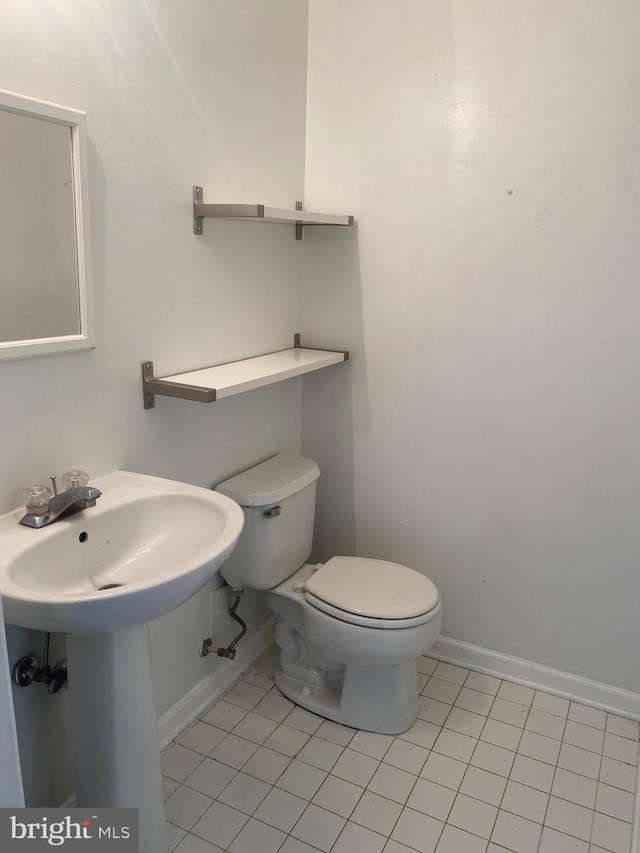 bathroom featuring tile patterned flooring, sink, and toilet