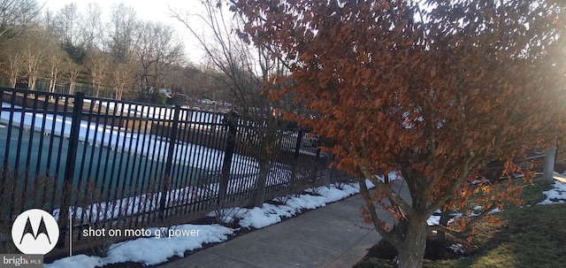 snow covered gate with a covered pool