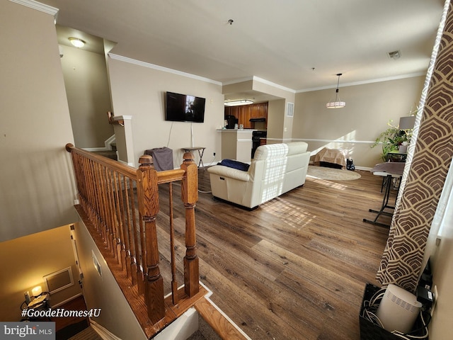 living room featuring hardwood / wood-style flooring and ornamental molding