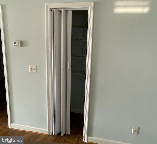 corridor featuring dark hardwood / wood-style flooring